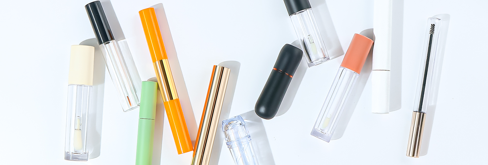 Minimalist display of white cosmetic bottles and packaging designs with dramatic shadows